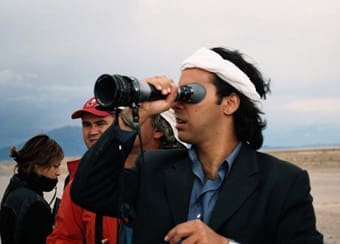 Marco Enríquez-Ominami con cámara en mano y banda en la cabeza, durante una grabación en exteriores como director de cine.